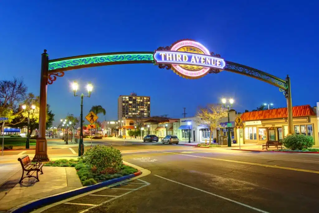 Chula Vista Third Avenue archway illuminated at night with street lights and surrounding buildings