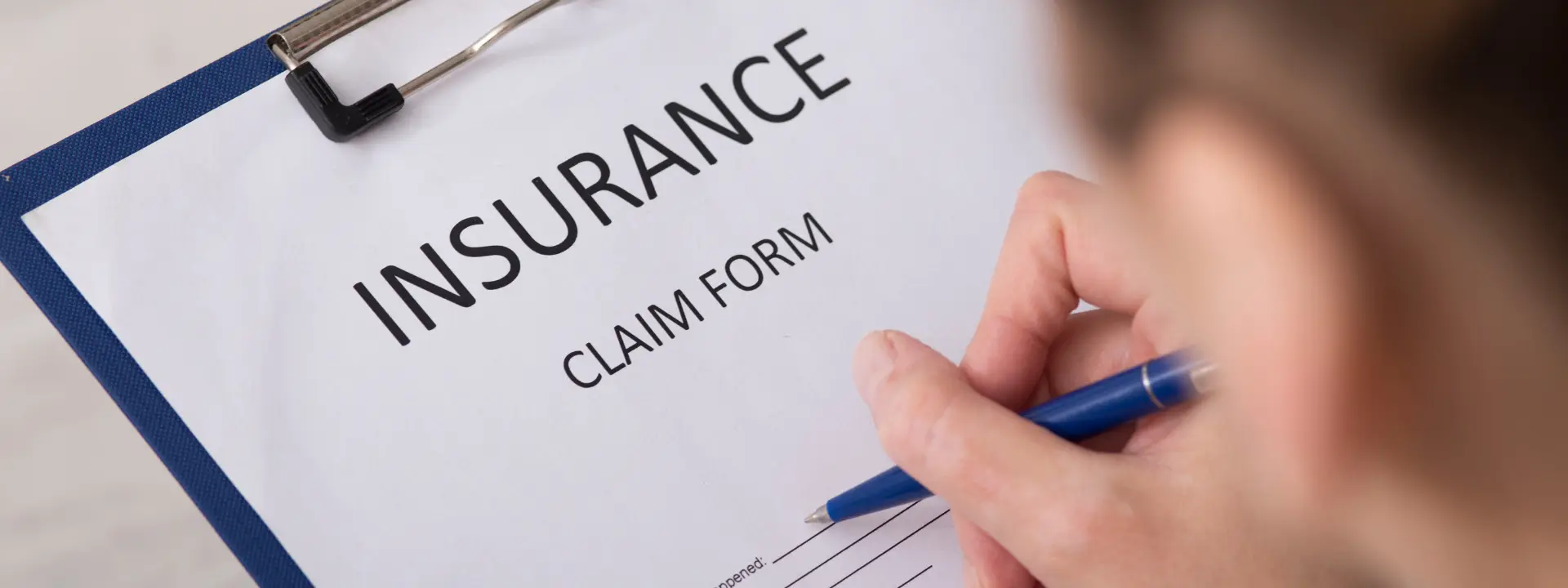 Individual smiling during therapy session, relieved after learning insurance covers treatment