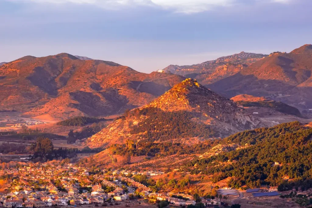 Individual walking through a peaceful neighborhood while experiencing inner anxiety and stress