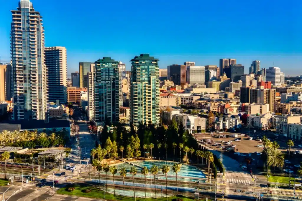 View of San Francisco skyline from the Golden Gate Bridge, showcasing iconic buildings against a clear blue sky.